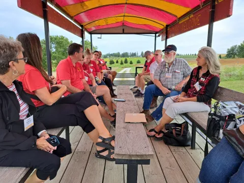 Tour Group B rides the people hauler at the ISU Horticulture Research Station.