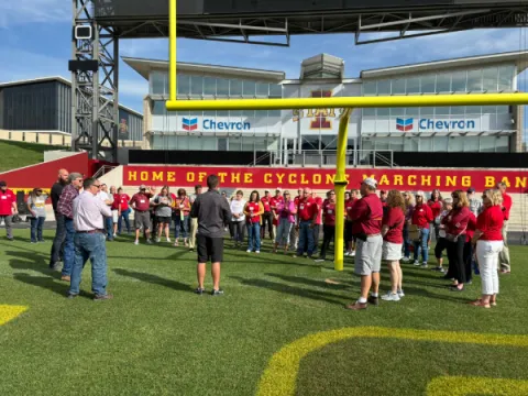 Extension Council Day on Campus participants listen to a presentation about the turf at Jack Trice Stadium