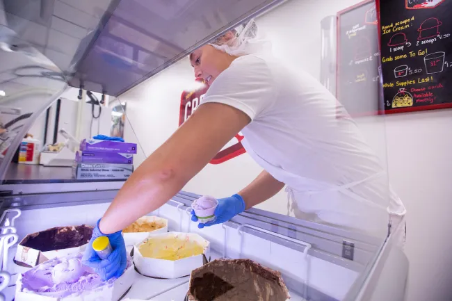 Woman scooping ice cream at the ISU Creamery